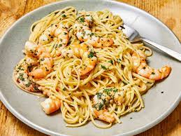 Shrimp scampi is a classic Italian-American delight, where succulent shrimp meet a medley of garlic, butter, and white wine. Sautéed to pink perfection, the shrimp mingle with a fragrant blend of garlic and red pepper flakes. A drizzle of white wine and a squeeze of lemon create a luxurious sauce, embracing the dish's linguine base. With a sprinkle of parsley, it's a harmonious, flavorful masterpiece that exemplifies both simplicity and taste.
            